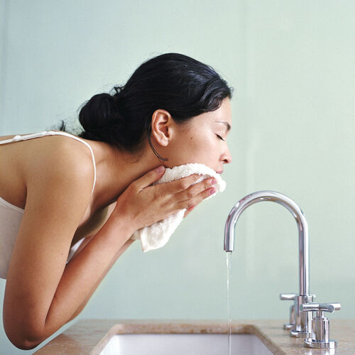 Woman exfoliating her skin